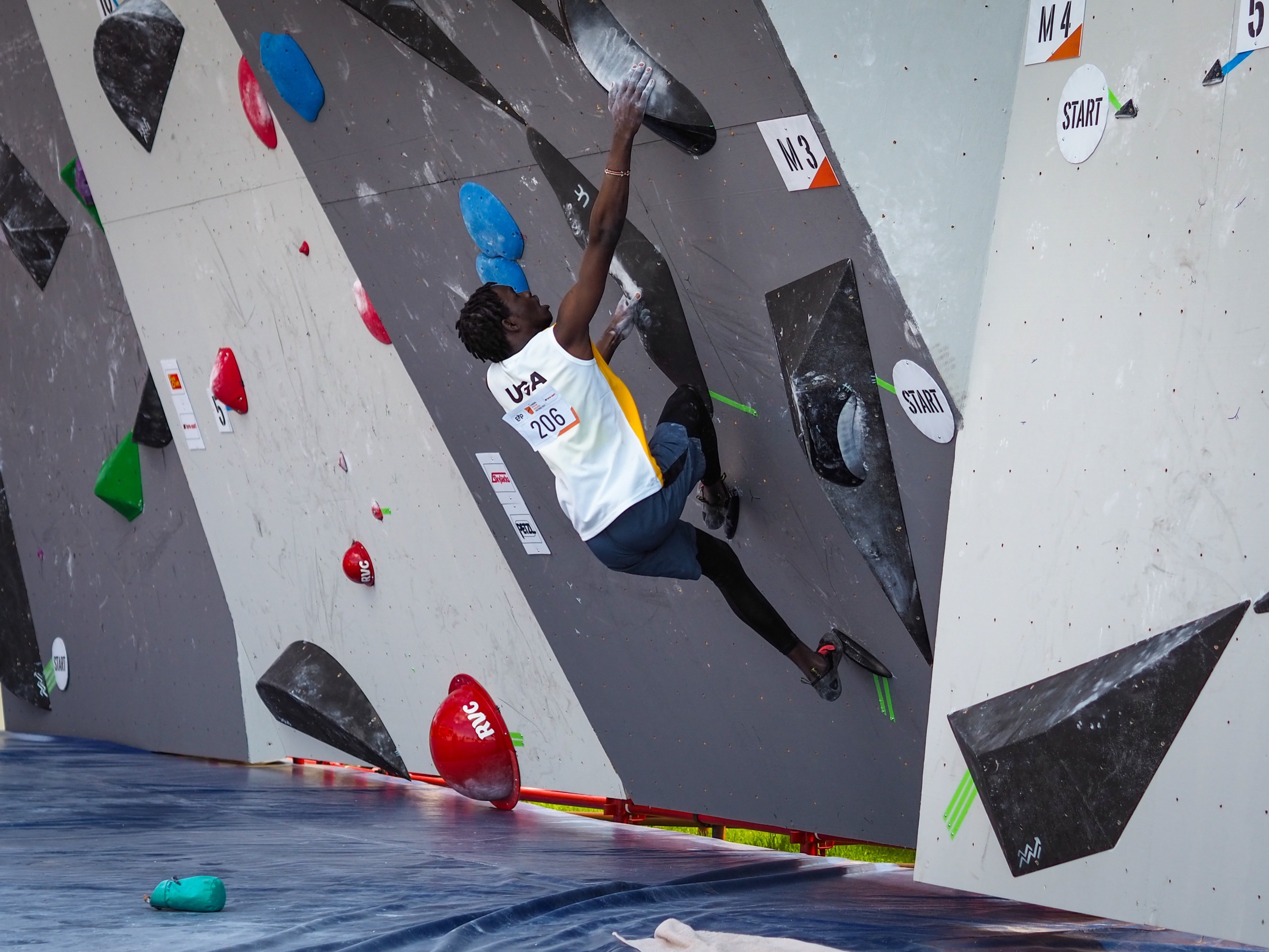 Uganda athlete Emmanuel Onyango competing in bouldering